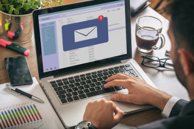 E- posta bildirim konsepti, bilgisayar laptopuyla çalışan bir adam, ekranda yeni bir e-posta kutusu mesajı, iş yerinin arka grubu