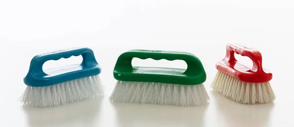 Cleaning Brushes Isolated White Background Plastic Brushes Vibrant Colors Hand — Stock Photo, Image