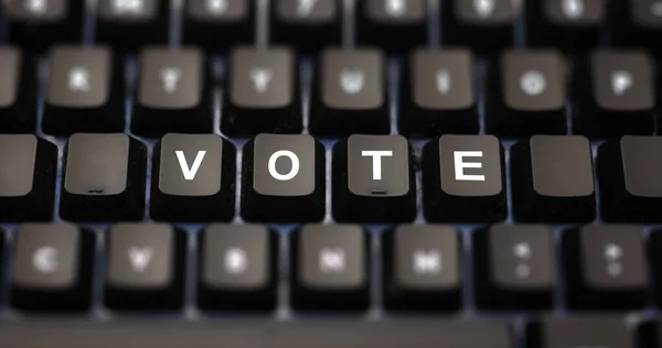Online voting concept. Vote word written on keypad. Black keys with white letters message for election on pc keyboard. Blur buttons background.