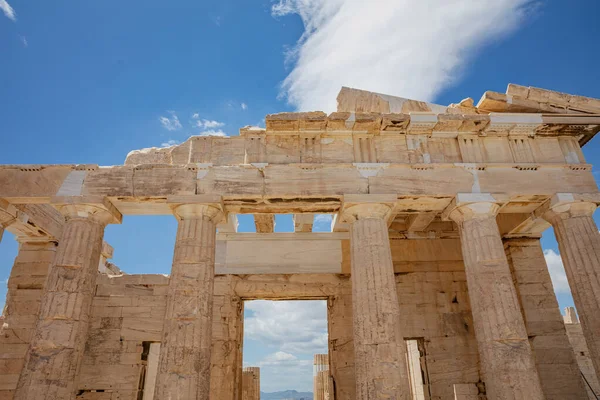 Athens Acropolis, Greece landmark. Ancient Greek Propylaea entrance gate ceiling and pillars low angle view, blue sky, spring sunny day.