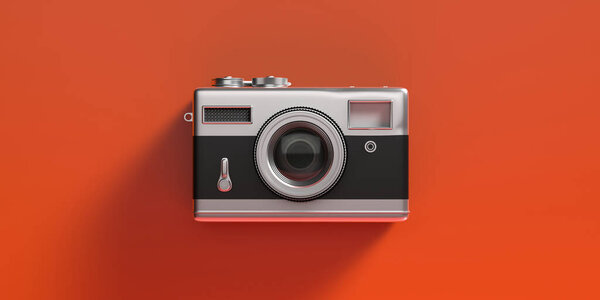 Photo camera vintage style. Retro old fashioned camera isolated on orange color background. 3d illustration