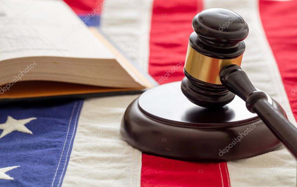 Law studies in USA. Judge gavel and open book on US of America flag background. Justice in USA concept