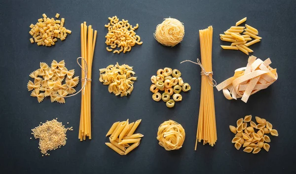 Pasta Cooking Concept Raw Pasta Shapes Variety Flat Lay Black — Stock Photo, Image