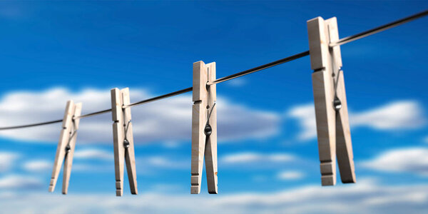 Clothespins on clothes cord against blur blue sky background. Laundy drying retro tools, pegs for clothes hanging. 3d illustration