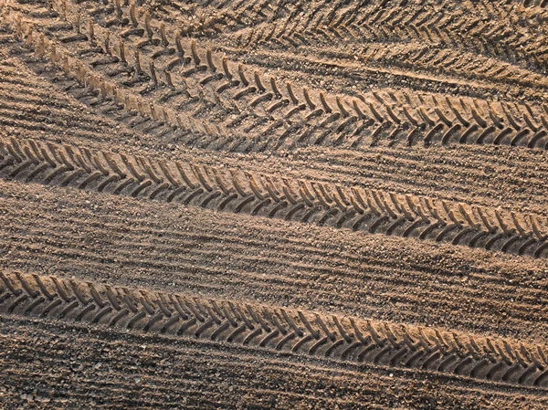 Spring arable land. Field and beautiful patterns from the tractor. View from above.