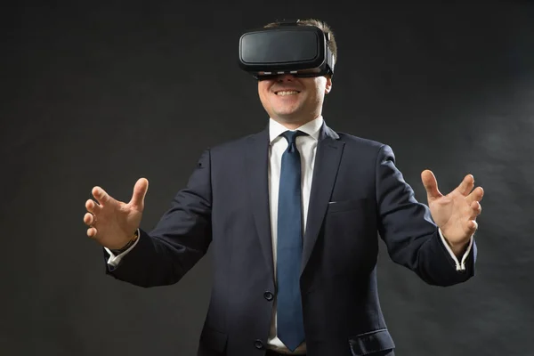 Man in black suit uses a virtual reality glasses.  VR 360. Virtual game