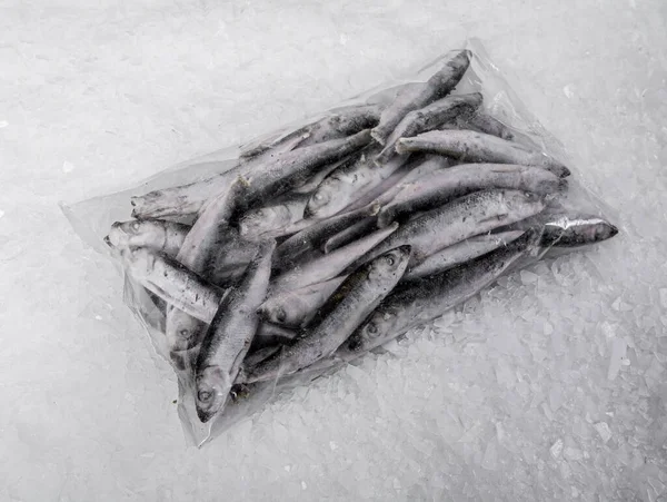 A plastic bag with fresh organic sea fish on the ice. Organic seafood. Close-up.