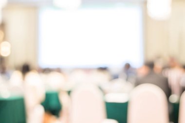 Ortam aydınlatmalarıyla dolu modern bir konferans salonunun bulanık görüntüsü