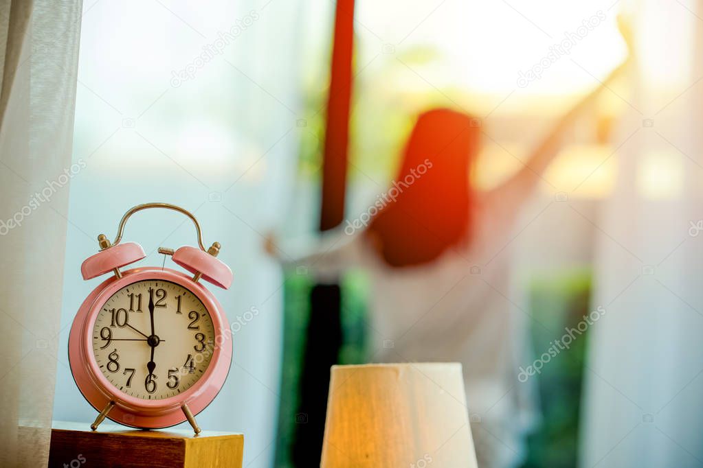 alarm clock wake up woman in the room