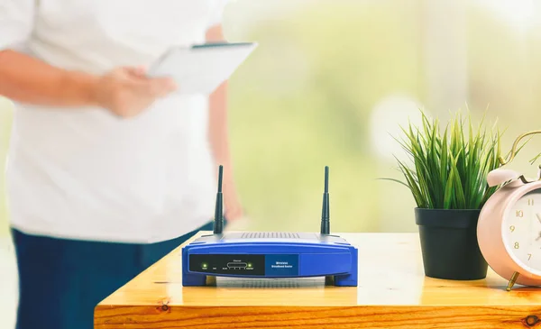 Closeup Wireless Router Man Using Smartphone Living Room Home Ofiice — Stock Photo, Image