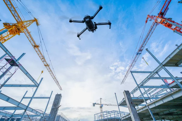 Drone over construction site. video surveillance or industrial inspection