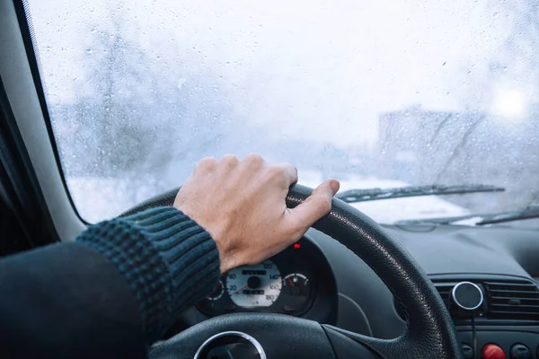 Icy road winter road. Winter conditions on the road. View of the driver.