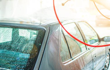 Mavi arabanın manuel oto yıkamada yakın çekimi.