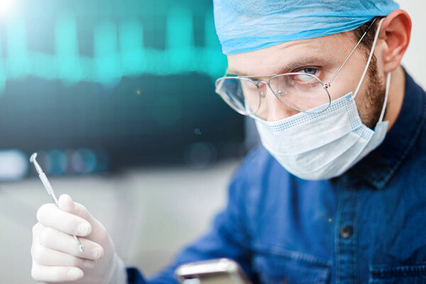 Thoughtful look of male doctor in uniform and glasses. Concept of hard work in medicine.