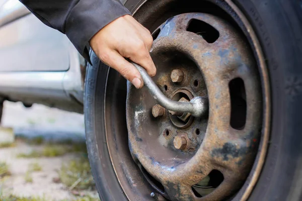 Closeup Man Replacing Wheel Car Loosening Nuts Hand Wrench — Stock Photo, Image