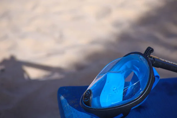 full face snorkeling mask on the beach.