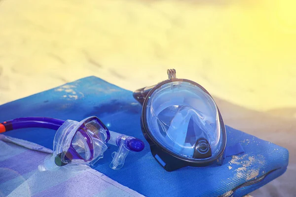 two types of snorkeling masks, full face and goggles with a snorkel for breathing. masks on the beach