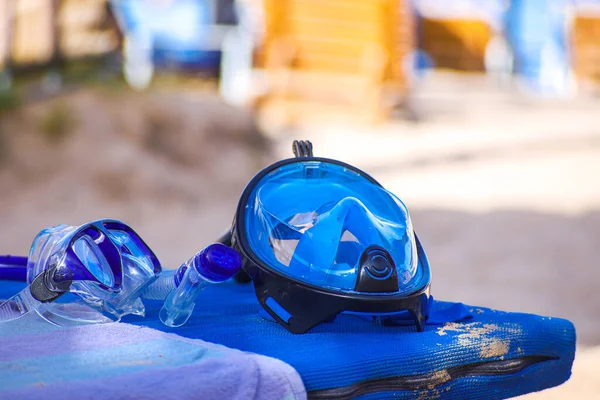 two types of snorkeling masks, full face and goggles with a snorkel for breathing. masks on the beach