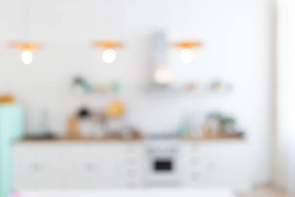 blurred background of modern kitchen light colors.