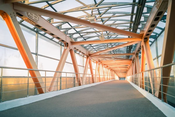 Modern metal bridge construction. Pedestrian crossing over a highway