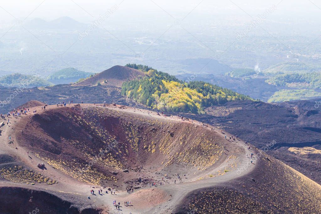 Groups of tourists walking along Etna mountain. Sicily island, Italy