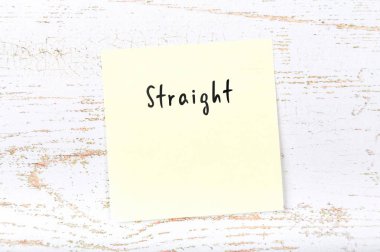 El yazısıyla yazılan kelime düz ile sarı yapışkan not