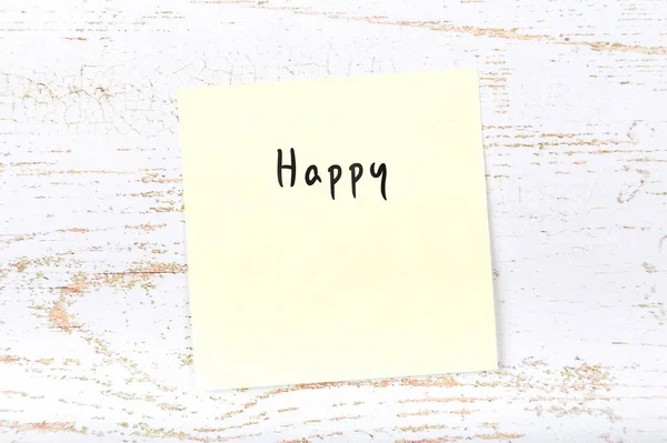 Żółtą karteczkę z odręcznym wyraz szczęśliwy — Zdjęcie stockowe