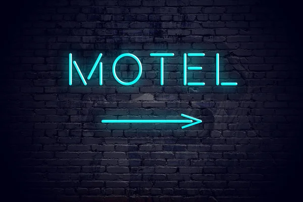 Mur en brique avec flèche néon et motel signe — Photo