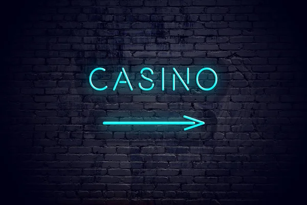 Brick wall with neon arrow and sign casino