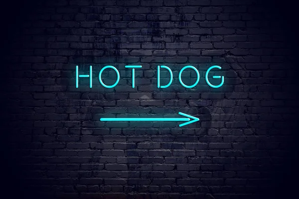 Brick wall with neon arrow and sign hot dog