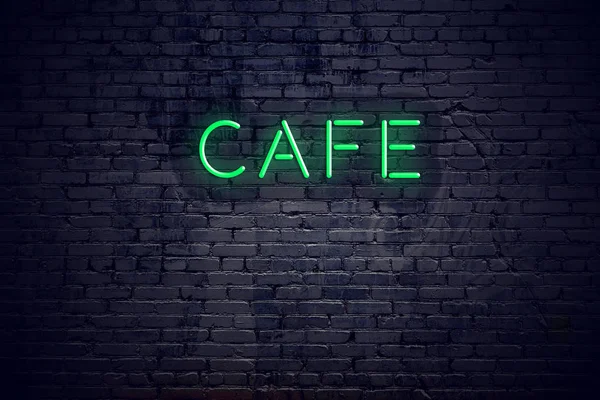 Brick wall at night with neon sign cafe
