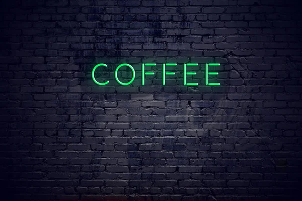 Brick wall at night with neon sign coffee