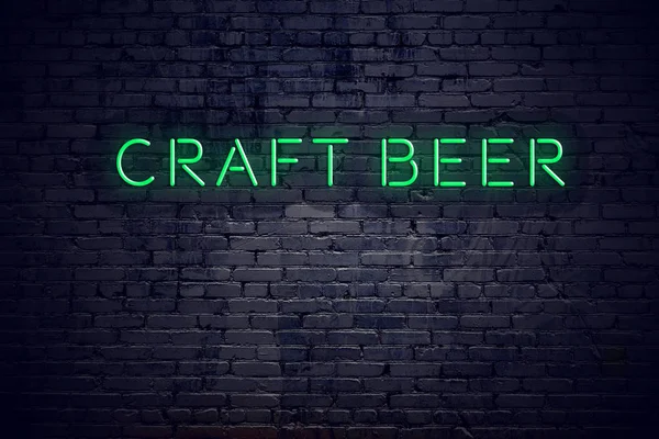 Цегляна стіна вночі з неоновим знаком крафтового пива — стокове фото