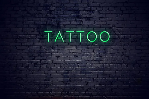 Brick wall at night with neon sign tattoo