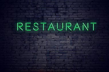 Neon işareti restoran ile gece tuğla duvar