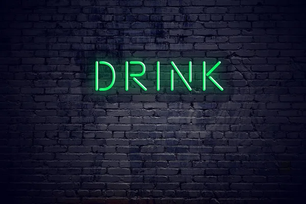Brick wall at night with neon sign drink