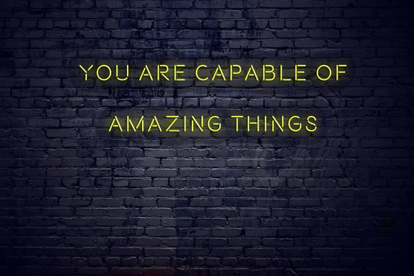 Positive inspiring quote on neon sign against brick wall you are capable of amazing things — Stock Photo, Image