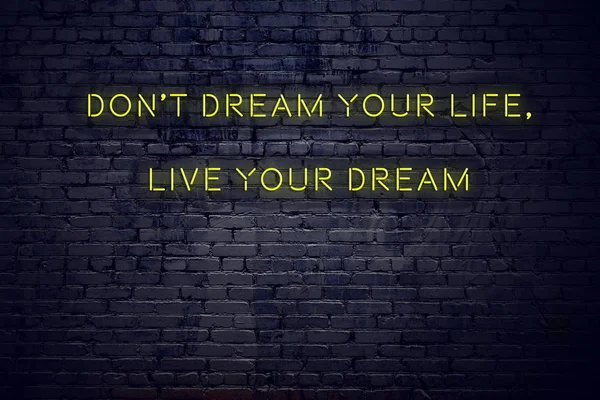 Positive inspiring quote on neon sign against brick wall dont dream your life live your dream — Stock Photo, Image