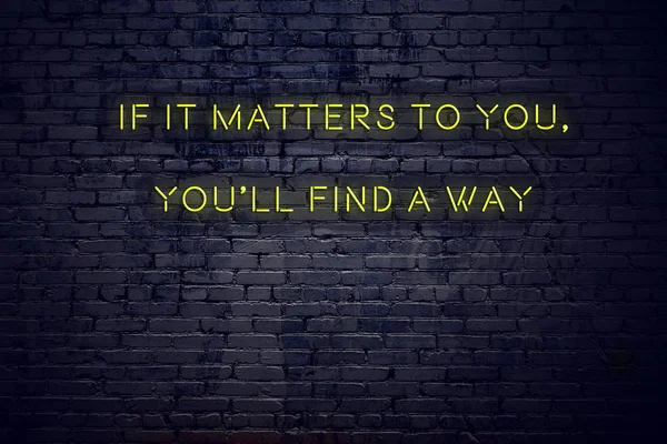 Positive inspiring quote on neon sign against brick wall if it matters to you youll find a way — Stock Photo, Image