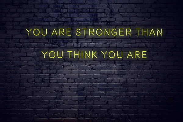 Positive inspiring quote on neon sign against brick wall you are stronger than you think you are — Stock Photo, Image