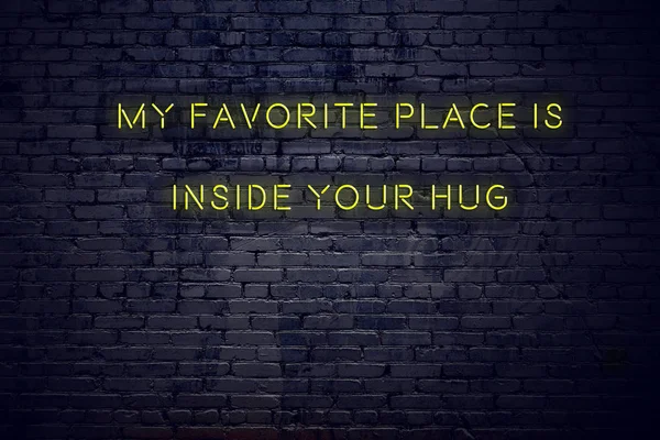 Positive inspiring quote on neon sign against brick wall my favorite place is inside your hug