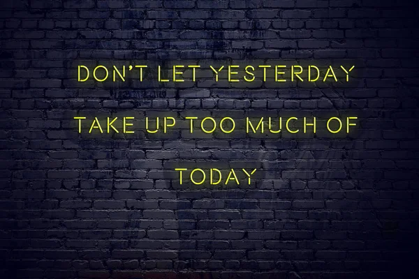 Positive inspiring quote on neon sign against brick wall dont let yesterday take up too much of today — 스톡 사진