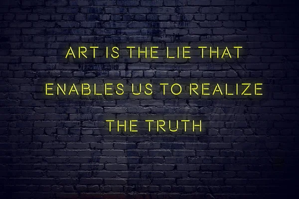 Positive inspiring quote on neon sign against brick wall art is the lie that enables us to realize the truth