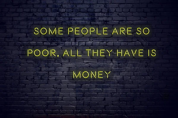 Citation inspirante positive sur néon signe contre mur de briques certaines personnes sont si pauvres tout ce qu'ils ont est de l'argent — Photo