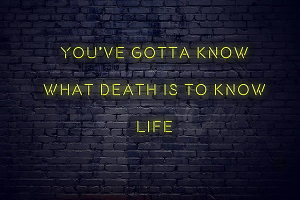 Positive inspiring quote on neon sign against brick wall youve gotta know what death is to know life — Stockfoto