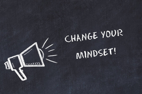 Chalk board sketch with loudspeaker and motivational phrase change your mindset