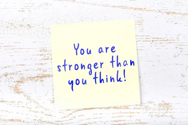 Yellow sticky note with handwritten text you are stronger than you think