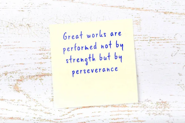 Positive inspiring quote handwritten on sticky note