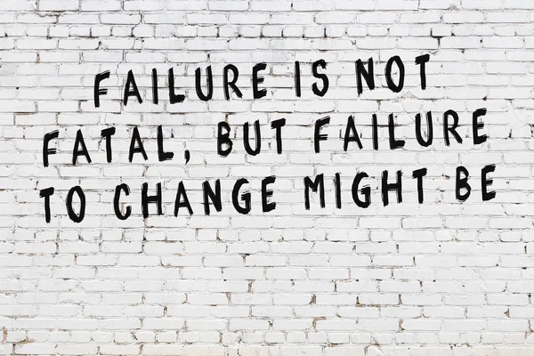 White brick wall with painted black motivational quote inscription — Stock Photo, Image