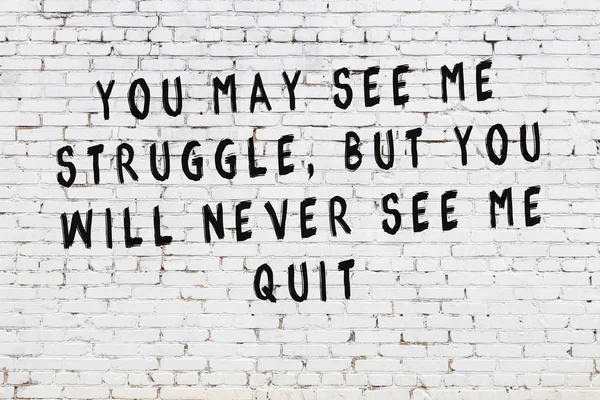 White brick wall with painted black motivational quote inscription — Stock Photo, Image